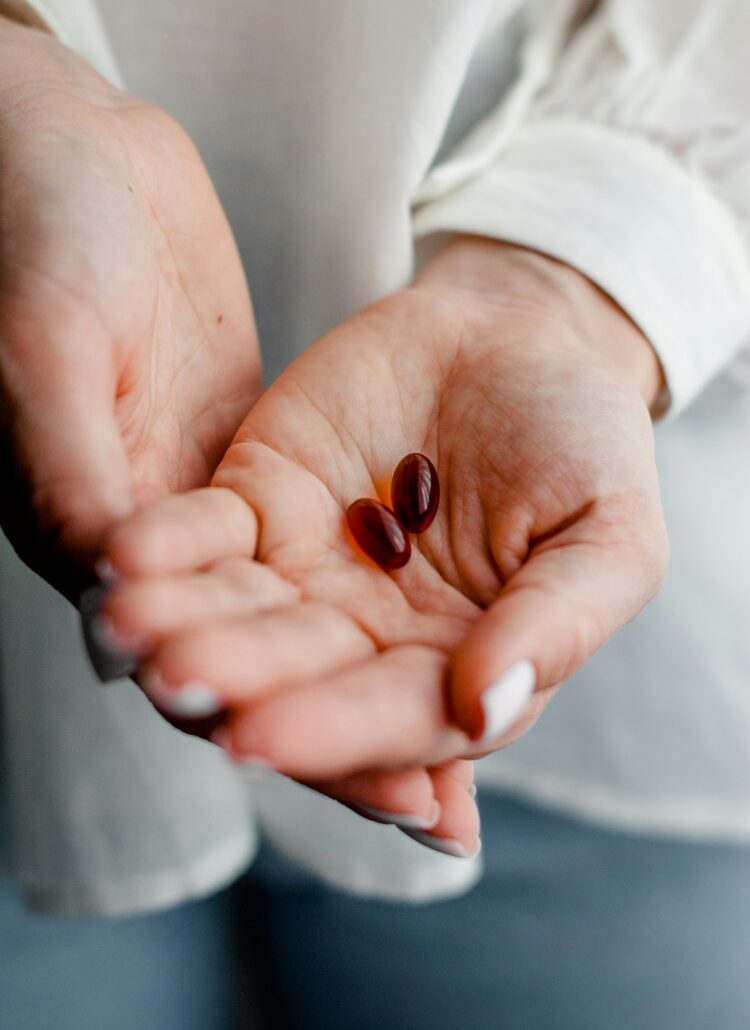 person holding brown and black round ornament